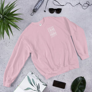A light pink sweatshirt laying with jeans and shoes. The pink sweatshirt features the word "create, create, create, create, create" in white in a small rectangle on the upper left side.