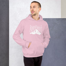 Load image into Gallery viewer, A man wearing a light pink hoodie with lettering and illustration in white with the phrase “Be Adventurous” with arrows pointing to the word “be” and a mountain illustration underneath the word “adventure.”