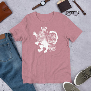 A pink orchid short sleeved T-shirt laying flat with objects around it. The T-Shirt features hand drawn illustration of the Chronicles of Narnia lion character Aslan. Inside the illustration there is the quote "Course He Isn't Safe, But He's Good. He's the King."