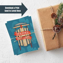 Load image into Gallery viewer, A stack of Christmas cards with brown string wrapped around them. A brown craft paper gift is off to the side. The card has a blue background with lighter blue winter mittens in a pattern. On top of the mittens is an illustrated vintage sled with red ribbon and the words &quot;season&#39;s greetings&quot; in white. The words &quot;download &amp; print, send to loved ones&quot; is in the upper lefthand corner of the image.