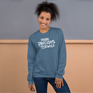 A indigo blue sweatshirt featuring the phrase More Precious Than Jewels in white lettering. This Christian sweatshirt is inspired by Proverbs 3.