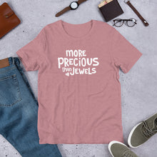 Load image into Gallery viewer, This short sleeved T-shirt features the words More Precious Than Jewels in white on an orchid pink colored tee. There is a small jewel featured at the bottom corner of the words. This T-shirt is inspired by Proverbs 3:15-18.
