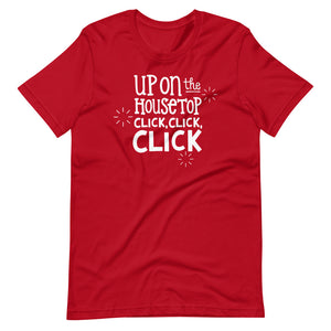 A red T-shirt on a white background. The navy shirt features words in white reading "Up on the housetop, click, click, click" in white. There are three stars around the words in white. 