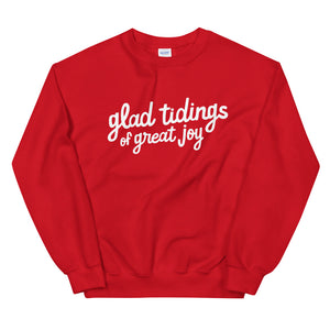 A red sweatshirt on a white background. The sweatshirt has the words "glad tidings of great joy" in white.