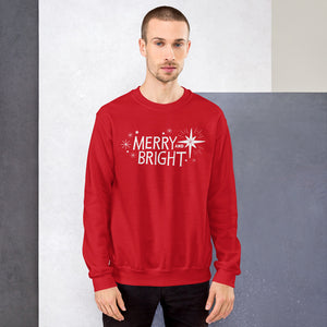 A man wearing a red sweatshirt featuring hand drawn lettering and star illustrations in white. The words Merry and Bright are in the middle with white stars surrounding the words. 