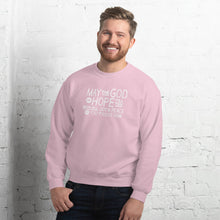 Load image into Gallery viewer, A man wearing a light pink sweatshirt featuring hand drawn lettering in white with the words &quot;May the God of hope fill you with all joy and peace as you trust him.&quot;