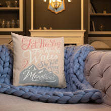 Load image into Gallery viewer, A pink cushion sits on a living room sofa with a chunky knitted purple blanket. The cushion reads &#39;Let her sleep for when she wakes she will move mountains&#39; in a pink, white, and light grey lettering design, with a grey mountain illustration at the bottom.