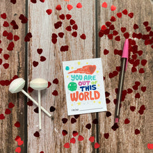 Load image into Gallery viewer, An image of a single classroom Valentine with heart confetti and Valentine’s sweets around it. The design features the words “You are out of this world” with space themed illustrations.