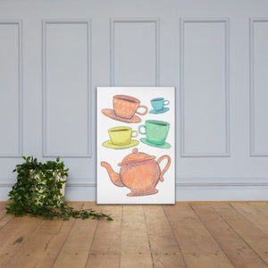 A canvas is leaning against a light grey wall with a plant next to it on the floor. The artwork is on a white background with four teacups on saucers and one large teapot. The teacups are in muted colors of orange, blue, yellow and green and the teapot is a muted orange. On the teacups, saucers and teapot there is a light flower detail pattern.