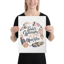 Load image into Gallery viewer, A woman holding a canvas in her hands. The canvas has a white background with the words &quot;Tender Warriors Are Being Made Here&quot; The words are in pink, navy and dark mustard yellow. 