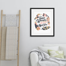 Load image into Gallery viewer, Framed artwork in a black frame on a wall above a sofa featuring a white paper print with hand drawn lettering and illustrations with the words &quot;Tender Warriors Are Being Made Here&quot; The words are in pink, navy and dark mustard yellow. 