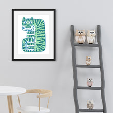 Load image into Gallery viewer, A black frame with a tiger illustration in the inside of the frame. The illustration features a light green tiger. The frame is on the wall of a nursery with a shelf with toys off to the side. 