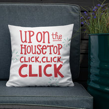 Load image into Gallery viewer, The white pillow is leaning on a sofa with a plant off to the side. The pillow is white and has the words in red saying &quot;Up on the housetop, click, click, click.&quot; There are three blue stars around the words. 