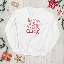 Load image into Gallery viewer, A white sweatshirt laying on a table with Christmas objects around it. The sweatshirt features the words &quot;Up on the housetop, click, click, click&quot; in red. There are three blue stars around the letters. 