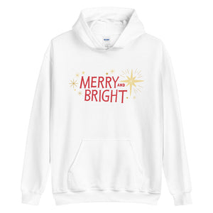 A white hoodie on a white background. The hoodie features the words Merry and Bright in red with illustrated stars around the words in yellow. 