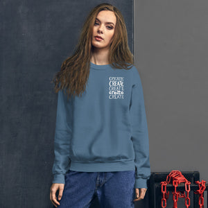 A woman wearing an indigo blue sweatshirt with the word "create, create, create, create, create" in white in a small rectangle on the upper left side.