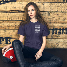 Load image into Gallery viewer, A woman wearing a navy short sleeved t-shirt. The tee features the lettering and illustration in white. The phrase &quot;create, create, create, create, create&quot; is in a small rectangle on the upper left side. 