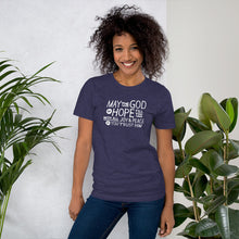 Load image into Gallery viewer, A woman wearing a heather midnight blue color short sleeved t-shirt. The t-shirt features hand drawn lettering in white with the words &quot;May the God of hope fill you with all joy and peace as you trust him.&quot;