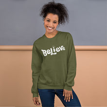 Load image into Gallery viewer, A woman wearing a hunter green sweatshirt featuring hand drawn lettering with the word Believe. The &quot;I&quot; of the word Believe is an illustrated Christmas tree. 