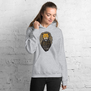 A woman wearing a light grey hoodie. The hoodie features hand drawn illustration of the Chronicles of Narnia lion character Aslan. Inside the illustration there is the quote “At The Sound of Your Roar, Sorrows Will Be No More.”