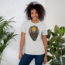 Load image into Gallery viewer, A woman wearing a light grey short sleeved t-shirt. The T-Shirt features hand drawn illustration of the Chronicles of Narnia lion character Aslan. Inside the illustration there is the quote “At The Sound of Your Roar, Sorrows Will Be No More.”