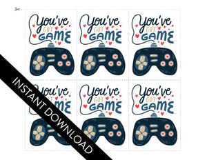 The set of six classroom Valentines shown with the design. The words “instant download” are over the image. The design features the words “You’ve got game” with an illustrated gaming controller. 